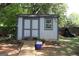 Exterior view of weathered storage shed with gray painted trim and a small ramp leading up to it at 4793 Davenport Nw Trce, Acworth, GA 30101