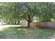 View of a expansive yard featuring mature trees and a long wooden privacy fence at 4793 Davenport Nw Trce, Acworth, GA 30101