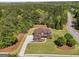 Aerial view of a two-story home surrounded by trees and lush landscaping at 189 Willowleaf Way, Sharpsburg, GA 30277