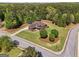 Aerial view of a home on a corner lot with mature trees and a large, well-manicured lawn at 189 Willowleaf Way, Sharpsburg, GA 30277