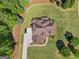 Bird's eye view of a brown home with a long driveway surrounded by mulch and a well-kept lawn at 189 Willowleaf Way, Sharpsburg, GA 30277