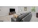 Finished basement features a comfortable sectional sofa, TV, and a large ottoman at 189 Willowleaf Way, Sharpsburg, GA 30277