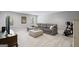 Spacious basement featuring a comfortable sectional sofa, ottoman, and modern entertainment area at 189 Willowleaf Way, Sharpsburg, GA 30277