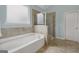 Elegant bathroom features a separate tub and shower, plus tile floors at 189 Willowleaf Way, Sharpsburg, GA 30277