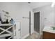 Bright half bathroom with a large mirror, single vanity, and an open doorway at 189 Willowleaf Way, Sharpsburg, GA 30277