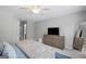 Neutral bedroom featuring a ceiling fan, dresser with television, and plush bedding for a cozy retreat at 189 Willowleaf Way, Sharpsburg, GA 30277