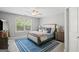Bright bedroom with ceiling fan, rug, and natural light from a large window at 189 Willowleaf Way, Sharpsburg, GA 30277