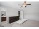 Serene bedroom showcasing a wooden dresser and a glimpse into an adjoining bathroom at 189 Willowleaf Way, Sharpsburg, GA 30277