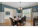 Dining room with hardwood floors, wainscoting, and a view of an arched alcove at 189 Willowleaf Way, Sharpsburg, GA 30277