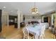 Open dining area with a table and chairs, connecting to the kitchen and living spaces at 189 Willowleaf Way, Sharpsburg, GA 30277