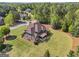 Wide aerial view of a home with a manicured lawn, mature trees, and mulch at 189 Willowleaf Way, Sharpsburg, GA 30277