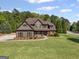 Charming two-story home with a well-manicured lawn, detailed trim and a walkway to the front door at 189 Willowleaf Way, Sharpsburg, GA 30277