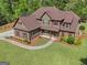 Aerial view of a home featuring detailed trim, lush landscaping, and a walkway leading to the front door at 189 Willowleaf Way, Sharpsburg, GA 30277