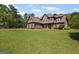 Charming two-story home with a spacious, well-manicured lawn and mature trees surrounding the property at 189 Willowleaf Way, Sharpsburg, GA 30277