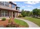 Close-up of the front entrance, with a paved walkway and verdant landscaping that leads to a charming two-story home at 189 Willowleaf Way, Sharpsburg, GA 30277
