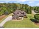 Aerial view of a two-story home on a spacious, well-manicured lawn with mature trees surrounding the property at 189 Willowleaf Way, Sharpsburg, GA 30277