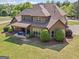 A high angle side view of a brown home with a covered patio and well manicured lawn at 189 Willowleaf Way, Sharpsburg, GA 30277