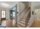 Welcoming foyer with hardwood floors and an elegant staircase at 189 Willowleaf Way, Sharpsburg, GA 30277