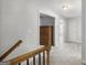 Bright hallway with neutral carpet leads to bedrooms and features a built-in dresser at 189 Willowleaf Way, Sharpsburg, GA 30277