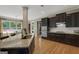 Well-equipped kitchen featuring dark wood cabinets, granite counters, and an adjacent dining area at 189 Willowleaf Way, Sharpsburg, GA 30277