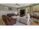 Comfortable living room featuring plush seating, a wooden entertainment center, and natural light at 189 Willowleaf Way, Sharpsburg, GA 30277