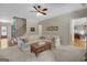 Spacious living room with a comfortable sectional sofa, wood floors, and natural light at 189 Willowleaf Way, Sharpsburg, GA 30277