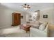 Inviting living room featuring a cozy sofa, wooden coffee table, and elegant ceiling fan at 189 Willowleaf Way, Sharpsburg, GA 30277