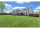 Vast backyard with a covered patio, perfect for entertaining, surrounded by a wooden privacy fence at 150 Ivy Chase Loop, Dallas, GA 30157