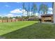 Expansive backyard with lush green grass, a covered patio, and privacy fence, providing a serene outdoor space at 150 Ivy Chase Loop, Dallas, GA 30157