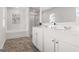 Modern bathroom features double sinks, white cabinetry, and a separate tub and shower at 150 Ivy Chase Loop, Dallas, GA 30157