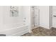 Modern bathroom features a tub, a walk-in shower, and tiled floor at 150 Ivy Chase Loop, Dallas, GA 30157