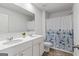 Bathroom featuring double sinks, white cabinetry, and a bathtub at 150 Ivy Chase Loop, Dallas, GA 30157