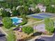 Aerial view featuring a community pool, tennis court, playground, and basketball court at 150 Ivy Chase Loop, Dallas, GA 30157