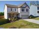 Beautiful two-story home featuring manicured landscaping, a well-kept lawn, and a paved driveway at 150 Ivy Chase Loop, Dallas, GA 30157