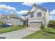 Attractive two-story home features a well-manicured lawn, gray siding, and an attached garage at 150 Ivy Chase Loop, Dallas, GA 30157