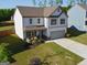 Aerial view of a well-maintained home with lush lawn, showcasing its charming curb appeal and inviting facade at 150 Ivy Chase Loop, Dallas, GA 30157