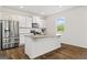 Stylish kitchen boasts a large island, granite counters, and stainless steel appliances at 150 Ivy Chase Loop, Dallas, GA 30157
