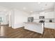 Open-concept kitchen with stainless steel appliances, granite countertops, a center island, and wood flooring at 150 Ivy Chase Loop, Dallas, GA 30157
