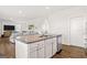 Island kitchen boasts stainless sink and appliances; opens to living area at 150 Ivy Chase Loop, Dallas, GA 30157