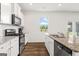 This kitchen offers white cabinets, granite countertops and stainless steel appliances at 150 Ivy Chase Loop, Dallas, GA 30157