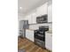 Modern kitchen with stainless steel appliances and white cabinets at 150 Ivy Chase Loop, Dallas, GA 30157