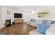 Living room with fireplace, TV, neutral walls, and wood-look flooring at 150 Ivy Chase Loop, Dallas, GA 30157