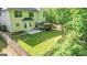 Expansive backyard featuring a well-maintained lawn, privacy fence, mature trees and a cozy patio area at 30 Saint Charles Pl, Sharpsburg, GA 30277