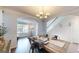 Inviting dining room showcasing hardwood floors, a chandelier, and seamless flow to the living area at 30 Saint Charles Pl, Sharpsburg, GA 30277