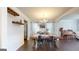 Elegant dining room with hardwood floors, chandelier, complemented by wine storage and piano in the background at 30 Saint Charles Pl, Sharpsburg, GA 30277