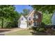 Charming two-story home featuring brick and siding accents, lush landscaping, and a welcoming front porch at 30 Saint Charles Pl, Sharpsburg, GA 30277