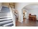 Elegant foyer with a staircase, hardwood floors, and an arched entryway leading to the living spaces at 30 Saint Charles Pl, Sharpsburg, GA 30277