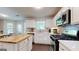 Modern kitchen featuring white cabinets, quartz countertops, stainless steel appliances, and a butcher block island at 30 Saint Charles Pl, Sharpsburg, GA 30277
