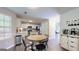 Bright kitchen with stainless appliances, white cabinets, a wood island and a breakfast table at 30 Saint Charles Pl, Sharpsburg, GA 30277