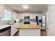 Bright kitchen featuring stainless steel appliances, white cabinets, butcher block island, and marble backsplash at 30 Saint Charles Pl, Sharpsburg, GA 30277